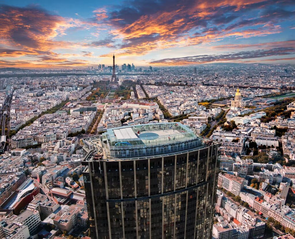 Paris skyline view from Montparnasse Tower at sunset, featuring the Eiffel Tower.